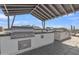 Outdoor kitchen area with grills and counter space, ideal for outdoor entertaining at 10004 S Smythe Dr, Apache Junction, AZ 85120