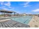 Community pool with covered seating area and lounge chairs for relaxation at 10004 S Smythe Dr, Apache Junction, AZ 85120
