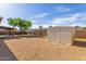 Large backyard with a storage shed, low maintenance landscaping, and covered patio at 1002 W Villa Rita Dr, Phoenix, AZ 85023