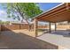 Large backyard with a covered patio, mature tree, and gravel landscaping at 1002 W Villa Rita Dr, Phoenix, AZ 85023