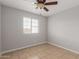 Bright bedroom featuring tile floors, a ceiling fan, and natural light at 1002 W Villa Rita Dr, Phoenix, AZ 85023
