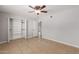 Bedroom featuring a ceiling fan, closet and tile floors at 1002 W Villa Rita Dr, Phoenix, AZ 85023