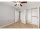 Well-lit bedroom with tile floors, ceiling fan, closet with folding doors, and accessible doorways at 1002 W Villa Rita Dr, Phoenix, AZ 85023