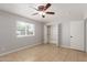 Bright bedroom with tile flooring, ceiling fan, window, and bi-fold closet at 1002 W Villa Rita Dr, Phoenix, AZ 85023