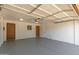 Spacious, clean garage interior with multiple entry doors and a functional garage door opener at 1002 W Villa Rita Dr, Phoenix, AZ 85023