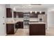 Modern kitchen featuring stainless steel appliances, an island, and dark wood cabinetry at 1002 W Villa Rita Dr, Phoenix, AZ 85023