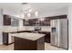 Bright kitchen with stainless steel appliances, granite countertops, and a center island at 1002 W Villa Rita Dr, Phoenix, AZ 85023