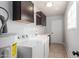Clean laundry room with modern appliances, cabinets, and ample counter space for folding at 1002 W Villa Rita Dr, Phoenix, AZ 85023
