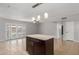 Open living space with a kitchen island, ceiling fan, and access to the backyard at 1002 W Villa Rita Dr, Phoenix, AZ 85023