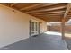 Covered patio with painted concrete, access doors to yard, offering outdoor living space at 1002 W Villa Rita Dr, Phoenix, AZ 85023