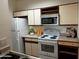Functional kitchen with white appliances, ample cabinet space, and a clean, efficient layout at 1126 W Elliot Rd # 1058, Chandler, AZ 85224