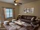 Comfortable living room features a leather sofa, stylish rug, and a ceiling fan for added comfort at 1126 W Elliot Rd # 1058, Chandler, AZ 85224