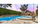Beautiful community pool with lounge chairs and manicured greenery creating a relaxing oasis at 1126 W Elliot Rd # 1058, Chandler, AZ 85224