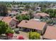 Aerial view of the home with mature trees, landscaping, and well maintained community at 1226 E Greenway Cir, Mesa, AZ 85203