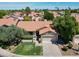 Aerial view of home with tile roof, desert landscaping, and lush green trees at 1226 E Greenway Cir, Mesa, AZ 85203