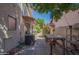 Walkway with AC unit, lush greenery, and cozy atmosphere, perfect for relaxing outdoors at 1226 E Greenway Cir, Mesa, AZ 85203