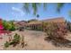 Landscaped backyard with covered patio, offering a tranquil outdoor living space at 1226 E Greenway Cir, Mesa, AZ 85203