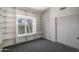 Bright bedroom featuring built-in bookshelves and a window seat overlooking a garden at 1226 E Greenway Cir, Mesa, AZ 85203