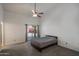 A simple bedroom with carpet and a sliding door to the backyard at 1226 E Greenway Cir, Mesa, AZ 85203