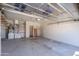 Spacious two-car garage with ample storage space and shelving at 1226 E Greenway Cir, Mesa, AZ 85203