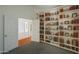 A home office complete with shelving and a view into the hallway at 1226 E Greenway Cir, Mesa, AZ 85203