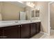 Bathroom featuring double sinks with white countertops, dark cabinets, and a large mirror at 1367 S Country Club Dr # 1299, Mesa, AZ 85210