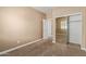 Bedroom featuring a closet with mirrored doors, neutral walls, and plush carpet flooring at 1367 S Country Club Dr # 1299, Mesa, AZ 85210