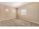 Bedroom featuring three bright windows, neutral walls, and plush carpet flooring at 1367 S Country Club Dr # 1299, Mesa, AZ 85210