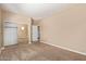 Bedroom featuring neutral walls, carpet, closet with mirrored doors, and a doorway at 1367 S Country Club Dr # 1299, Mesa, AZ 85210