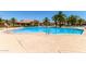 Resort-style community pool with palm trees and lounge chairs, ideal for relaxation and recreation at 1367 S Country Club Dr # 1299, Mesa, AZ 85210
