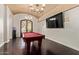 Game room featuring a pool table, dark hardwood flooring, chandelier, and large screen TV at 1367 S Country Club Dr # 1299, Mesa, AZ 85210