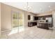 Bright open kitchen with stainless steel appliances, a granite countertop island, and sliding glass doors at 1367 S Country Club Dr # 1299, Mesa, AZ 85210