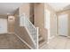 Carpeted staircase featuring white railings and tile floor entryway at 1367 S Country Club Dr # 1299, Mesa, AZ 85210