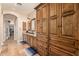 A luxurious bathroom features custom cabinetry, granite countertops, and double sinks with walk in closet access at 1508 N Alta Mesa Dr # 120, Mesa, AZ 85205