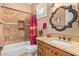 Bathroom featuring tile walls, shower with curtain, vanity and decorative mirror at 1508 N Alta Mesa Dr # 120, Mesa, AZ 85205