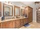 Bathroom with double sinks, granite countertops, tile flooring, and wooden cabinetry at 1508 N Alta Mesa Dr # 120, Mesa, AZ 85205
