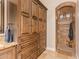 A luxurious bathroom features custom cabinetry and a stone walk-in shower with a built in bench at 1508 N Alta Mesa Dr # 120, Mesa, AZ 85205