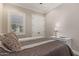 Bright bedroom has neutral decor, double door closet, and stylish furnishings and a window with plantation shutters at 1508 N Alta Mesa Dr # 120, Mesa, AZ 85205
