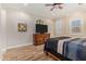 Bright bedroom featuring neutral tones, ceiling fan, and wood-look flooring at 1508 N Alta Mesa Dr # 120, Mesa, AZ 85205