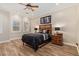 Comfortable bedroom with wood-look tile flooring, neutral colors, and ceiling fan at 1508 N Alta Mesa Dr # 120, Mesa, AZ 85205