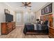 Cozy bedroom featuring a ceiling fan, wood-look tile flooring, and natural light at 1508 N Alta Mesa Dr # 120, Mesa, AZ 85205