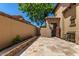 Home's private back courtyard featuring stone pavers and desert landscaping at 1508 N Alta Mesa Dr # 120, Mesa, AZ 85205