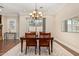 Inviting dining room featuring a dark wood table with seating and a decorative chandelier at 1508 N Alta Mesa Dr # 120, Mesa, AZ 85205