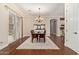 Bright dining room featuring a chandelier, hardwood floors, and sliding door to the backyard at 1508 N Alta Mesa Dr # 120, Mesa, AZ 85205