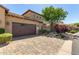 Exterior of home featuring a two-car garage, desert landscaping, and brick paver driveway at 1508 N Alta Mesa Dr # 120, Mesa, AZ 85205