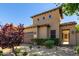 Charming home exterior featuring a two-car garage, desert landscaping, and stone pathway to the front courtyard at 1508 N Alta Mesa Dr # 120, Mesa, AZ 85205