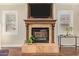 Living room fireplace with wood trim, tile detail, and a mounted television at 1508 N Alta Mesa Dr # 120, Mesa, AZ 85205