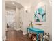Inviting hallway with wood floors, art display, and archway to a bedroom at 1508 N Alta Mesa Dr # 120, Mesa, AZ 85205