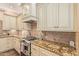 Close up of stylish kitchen with granite countertops, tile backsplash, and stainless appliances at 1508 N Alta Mesa Dr # 120, Mesa, AZ 85205