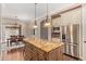 Kitchen featuring a granite island, stainless appliances, and access to the dining area at 1508 N Alta Mesa Dr # 120, Mesa, AZ 85205